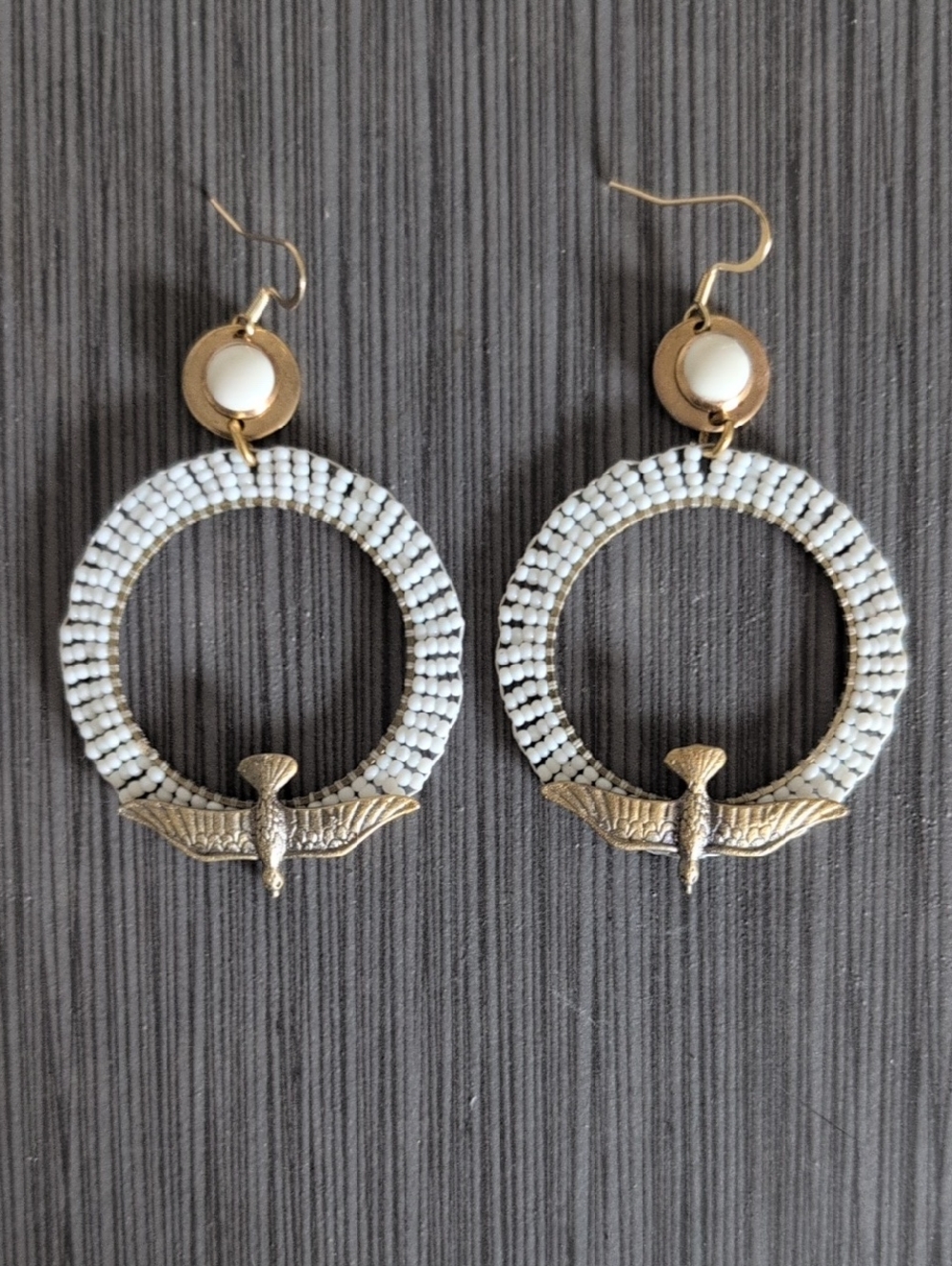 Gold-Brass Tone White Beaded Hoop Earrings with descending Bird Accent.